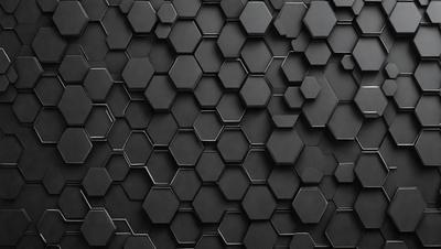 The primary subject of the image is a black and white patterned surface, which appears to be a wall or a piece of artwork. The setting is a dark room, and the visual style is a close-up of the patterned surface. The colors and mood of the image are predominantly dark and moody, with the black and white pattern creating a sense of depth and intrigue.