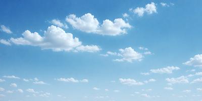 The primary subject of the image is a cloudy blue sky filled with fluffy white clouds. The setting is a vast open space, and the visual style is a natural, outdoor atmosphere. The colors and mood of the image are predominantly blue and white, creating a serene and peaceful ambiance.