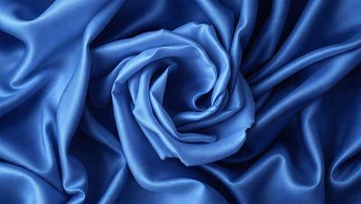 The primary subject of the image is a blue rose. The setting is a blue background, which creates a striking contrast with the blue rose. The visual style is a close-up of the rose, emphasizing its vibrant color. The dominant colors are blue and purple, giving the image a calm and serene atmosphere.