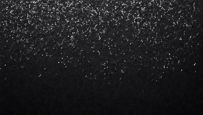 The primary subject of the image is a black background with a pattern of glittering stars. The setting is a dark, starry night, and the visual style is a combination of a photo and digital art. The colors are predominantly black, with the glittering stars adding a touch of brightness and contrast. The overall atmosphere is one of mystery and wonder, as the viewer is drawn into the starry night scene.
