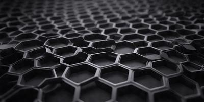 The primary subject of the image is a close-up of a black and white patterned surface, which appears to be a textured or patterned material. The setting is a dark background, which contrasts with the patterned surface. The visual style is a close-up, which emphasizes the details of the pattern. The colors and mood of the image are predominantly black and white, giving it a classic and timeless feel.
