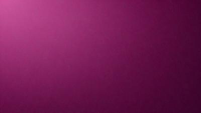 The primary subject of the image is a large, purple wall. The setting is a room with a pink background. The visual style is a close-up of the wall, which gives a sense of depth and texture. The dominant colors are purple and pink, creating a warm and inviting atmosphere.
