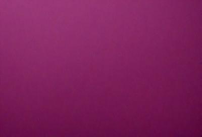The primary subject of the image is a large, purple wall. The setting is a room with a pink background. The visual style is a close-up of the wall, which gives a sense of depth and texture. The dominant colors are purple and pink, creating a warm and inviting atmosphere.