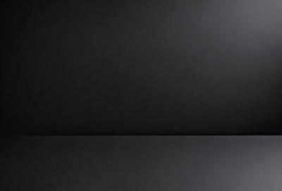 The primary subject of the image is a black background. The setting is a dark room, and the visual style is a black and white photo. The colors and mood of the image are predominantly dark and moody.