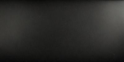 The primary subject of the image is a black background. The setting is a dark room, and the visual style is a black and white photo. The colors and mood of the image are predominantly dark and moody.