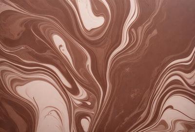 The primary subject of the image is a close-up of a marbled surface, which appears to be a piece of wood or a wall with a patterned texture. The setting is indoors, with the surface being the main focus of the image. The visual style is a close-up, which emphasizes the intricate details of the marbled surface. The colors and mood of the image are predominantly brown and earthy tones, giving it a natural and organic feel.