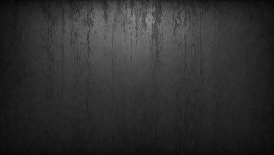 The primary subject of the image is a black and white photo of a wall with water droplets on it. The setting is a dark room, and the visual style is a close-up of the wall. The colors and mood of the image are dark and moody, with the black and white photo adding to the atmosphere.