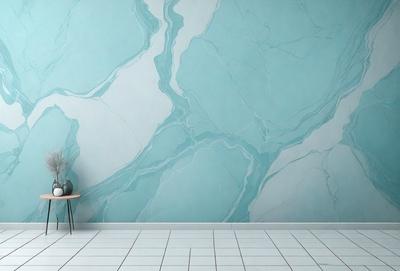 The primary subject of the image is a white vase placed on a wooden table. The setting is a room with a blue wall, which features a marble-like pattern. The visual style is a photo, and the dominant colors are white and blue. The overall atmosphere is clean and modern.