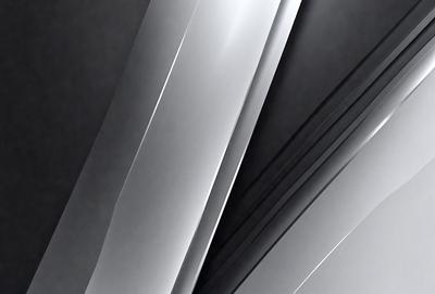 The primary subject of the image is a close-up of a silver metal surface. The setting is a black background, which contrasts with the silver metal. The visual style is a photo, showcasing the intricate details of the metal surface. The colors and mood of the image are predominantly black and silver, creating a sleek and modern atmosphere.