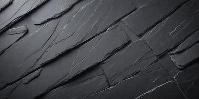 The primary subject of the image is a black stone wall. The setting is a dark room, and the visual style is a close-up of the stone wall. The colors and mood of the image are predominantly dark and moody, with the black stone wall being the main focus.