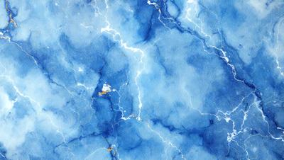 The primary subject of the image is a blue and white marbled wallpaper with a lightning bolt pattern. The setting is a blue and white marbled wall, which serves as the background. The visual style is a digital art or illustration, as the lightning bolt pattern is created through digital means. The dominant colors are blue and white, giving the image a calm and soothing atmosphere.