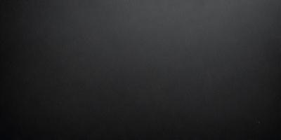 The primary subject of the image is a black background. The setting is a dark room, and the visual style is a black and white photo. The colors and mood of the image are dark and moody, creating a sense of mystery or drama.