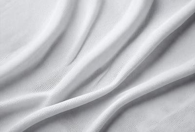 The primary subject of the image is a white sheet of fabric. The setting is a white background, which creates a clean and minimalist appearance. The visual style is a close-up of the fabric, showcasing its texture and details. The colors and mood of the image are predominantly white, giving it a calm and serene atmosphere.