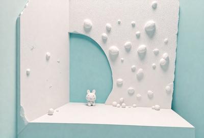 The primary subject of the image is a small white bunny figurine, which is sitting on a white surface. The setting appears to be a white room with a blue wall. The visual style of the image is a combination of photo and digital art, creating a unique and interesting scene. The dominant colors in the image are white and blue, giving it a clean and calming atmosphere.