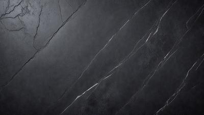 The primary subject of the image is a close-up of a black marble wall. The setting is a dark room, and the visual style is a photo. The dominant colors are black and grey, creating a moody atmosphere.