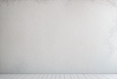 The primary subject of the image is a white wall with a white frame. The setting is a room with a wooden floor. The visual style is a photo, and the colors and mood are predominantly white, giving the image a clean and minimalist appearance.
