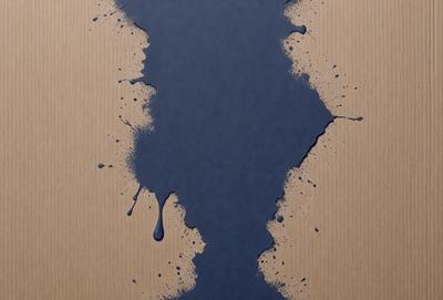 The primary subject of the image is a blue paint splatter on a wooden surface. The setting is a wooden table, and the visual style appears to be a close-up of the paint splatter. The dominant colors are blue and white, and the overall atmosphere is artistic and creative.
