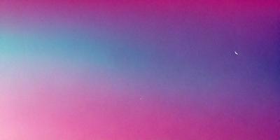 The primary subject of the image is a pink sky with a blue background. The sky appears to be a gradient, with the pink hue fading into the blue. The visual style of the image is a combination of photo and digital art, creating a unique and artistic representation of the sky. The colors and mood of the image are predominantly pink and blue, giving it a warm and serene atmosphere.