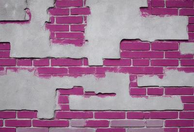 The primary subject of the image is a brick wall with a pinkish hue. The setting is a brick wall with a pinkish hue. The visual style is a photo. The colors and mood of the image are predominantly pink, giving it a warm and inviting atmosphere.