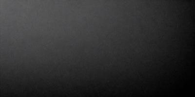 The primary subject of the image is a black background. The setting is a dark, empty space with no visible objects or elements. The visual style is a black and white photo, which gives the image a classic and timeless appearance. The colors and mood are predominantly dark and moody, creating a sense of mystery and depth.