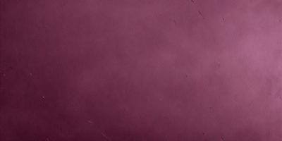 The primary subject of the image is a maroon leather surface. The setting is a room with a wall painted in a maroon color. The visual style is a close-up of the leather surface, which appears to be a leather book cover. The colors and mood of the image are warm and inviting, with the maroon color evoking a sense of comfort and luxury.