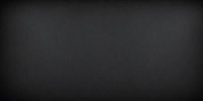 The primary subject of the image is a black background. The setting is a dark room, and the visual style is a black and white photo. The colors and mood of the image are predominantly dark and moody.
