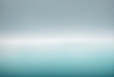 The primary subject of the image is a large body of water, which appears to be a vast ocean. The setting is a cloudy sky, creating a moody atmosphere. The visual style of the image is a photo, capturing the beauty of the ocean and the sky. The dominant colors are blue and gray, reflecting the calmness and vastness of the ocean.