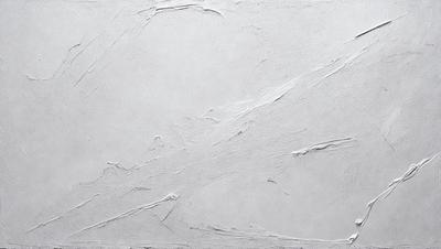 The primary subject of the image is a white wall with a pattern of peeling paint. The setting is a room with a white background. The visual style is a close-up of the wall, showcasing the peeling paint. The colors and mood of the image are predominantly white, giving it a clean and minimalist appearance.