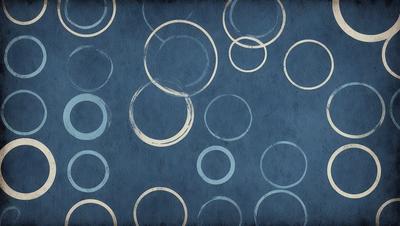 The primary subject of the image is a blue background with a pattern of circles. The circles are of various sizes and are arranged in a visually appealing manner. The setting is a blue background, and the visual style appears to be a combination of a photo and a pattern. The dominant colors are blue and white, creating a calm and soothing atmosphere.