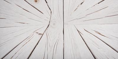 The primary subject of the image is a wooden plank with a unique, spiral-shaped design. The setting is a wooden floor, and the visual style appears to be a photo. The dominant colors are white and brown, giving the scene a natural and earthy atmosphere.