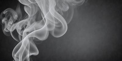 The primary subject of the image is a large, dark, and smoky cloud. The setting is a gray background, which contrasts with the cloud. The visual style is a black and white photo, giving the image a dramatic and moody atmosphere. The dominant colors are gray and black, with the cloud being the main focus of the image.