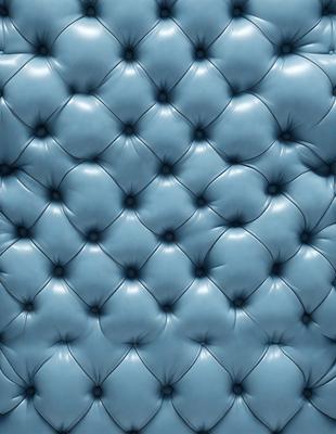 The primary subject of the image is a blue couch with a patterned design. The setting is a room with a blue background, and the visual style appears to be a photo. The dominant colors in the image are blue and white, creating a calm and relaxing atmosphere.