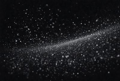 The primary subject of the image is a bright, white, and colorful star. The setting is a dark, black background, which contrasts with the star's vibrant colors. The visual style is a combination of a photo and digital art, creating a unique and eye-catching effect. The colors and mood of the image are lively and energetic, with the star's brightness and the contrasting darkness of the background creating a striking visual impact.