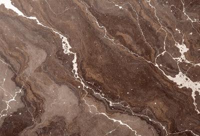 The primary subject of the image is a marble countertop with a brown and white pattern. The setting is a kitchen, and the visual style is a close-up of the marble countertop. The colors and mood of the image are warm and natural, with the brown and white marble creating a sense of elegance and sophistication.