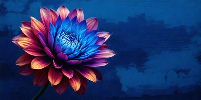 The primary subject of the image is a large, colorful flower with a purple and blue hue. The flower is prominently displayed in the foreground, with a blue background and a cloudy sky in the background. The visual style of the image is a combination of photo and digital art, creating a vibrant and eye-catching scene. The dominant colors of the image are purple and blue, which contribute to a calm and serene atmosphere.