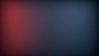 The primary subject of the image is a blue wall with a red stripe. The setting is a dark room, and the visual style appears to be a photo. The dominant colors are blue and red, creating a moody atmosphere.