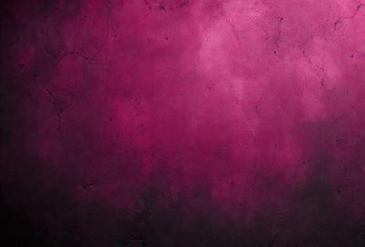The primary subject of the image is a large, purple wall. The setting is a room with a pink background. The visual style is a close-up of the wall, which gives a sense of depth and texture. The dominant colors are purple and pink, creating a warm and inviting atmosphere.