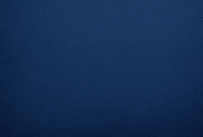 The primary subject of the image is a large, dark blue sky. The setting is a vast, open space with no visible landmarks or objects. The visual style is a natural, untouched landscape. The colors and mood are predominantly dark and moody, with the blue sky serving as the main focal point.