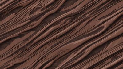 The primary subject of the image is a close-up of a brown, textured surface, possibly a piece of wood or a wall. The setting appears to be a natural environment, with the surface being the main focus of the image. The visual style is a close-up, which emphasizes the texture and details of the surface. The colors in the image are predominantly brown, giving the scene a warm and earthy atmosphere.