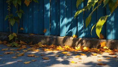 The primary subject of the image is a fence with a blue background. The setting is a sidewalk with a paved surface. The visual style is a photo, and the colors and mood are predominantly yellow and orange, giving the scene a warm and inviting atmosphere.
