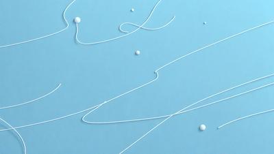The primary subject of the image is a close-up of a white string or yarn. The setting is a blue background, which creates a contrasting and visually appealing effect. The visual style is a close-up of the string, showcasing its texture and details. The colors and mood of the image are predominantly blue, giving it a calm and serene atmosphere.