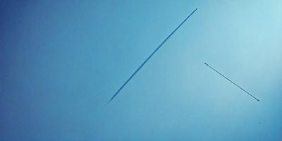 The primary subject of the image is a long, thin line that is drawn on a blue background. The line appears to be a representation of a rocket or a missile, and it is the main focus of the image. The setting is a blue sky, which provides a contrasting backdrop for the line. The visual style of the image is a combination of digital art and illustration, as the line is drawn with precision and attention to detail. The colors in the image are predominantly blue, which gives the image a calm and
