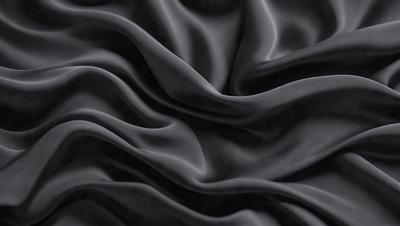 The primary subject of the image is a black fabric, which appears to be a piece of cloth or a curtain. The setting is a dark room, and the visual style is a close-up of the fabric. The colors and mood of the image are predominantly dark and moody, with the black fabric being the main focus.