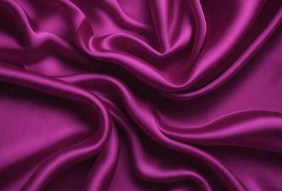 The primary subject of the image is a purple fabric, which is the main object, scene, or focus of the image. The setting or background is a purple sheet, and the visual style is a close-up of the fabric. The colors and mood of the image are predominantly purple, creating a calm and soothing atmosphere.
