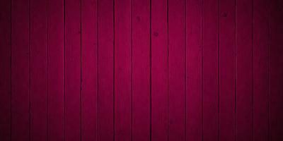 The primary subject of the image is a wooden wall with a red color. The setting is a room with a wooden surface, and the visual style is a close-up of the wooden wall. The dominant colors are red and brown, creating a warm and cozy atmosphere.