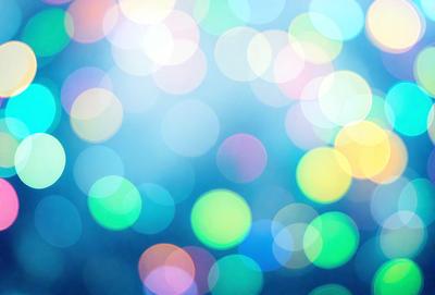 The primary subject of the image is a brightly colored, swirling pattern of lights. The setting is a blue background, which adds to the overall visual style. The image appears to be a digital art or illustration, as it is not a photo or a clipart. The dominant colors are blue and green, creating a vibrant and lively atmosphere.