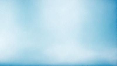 The primary subject of the image is a cloudy blue sky. The setting is a vast, open space with no visible landmarks or objects. The visual style is a natural, outdoor scene with a focus on the sky. The colors and mood are predominantly blue, creating a calm and serene atmosphere.
