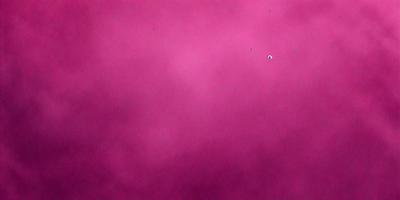 The primary subject of the image is a pink background. The setting is a cloudy sky, and the visual style is a photo. The dominant colors are pink and purple, creating a warm and inviting atmosphere.