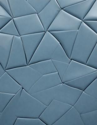 The primary subject of the image is a blue, textured surface with a patterned design. The setting is a close-up of the blue material, which appears to be a piece of fabric or a wall with a unique texture. The visual style is a close-up of the blue material, showcasing its intricate pattern and texture. The colors and mood of the image are predominantly blue, creating a calm and serene atmosphere.