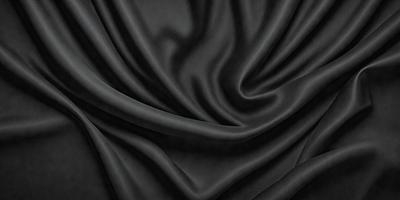The primary subject of the image is a black fabric, which is the main object, scene, or focus of the image. The setting or background is a black curtain, and the visual style is a close-up of the fabric. The colors and mood of the image are predominantly black, creating a dramatic and moody atmosphere.